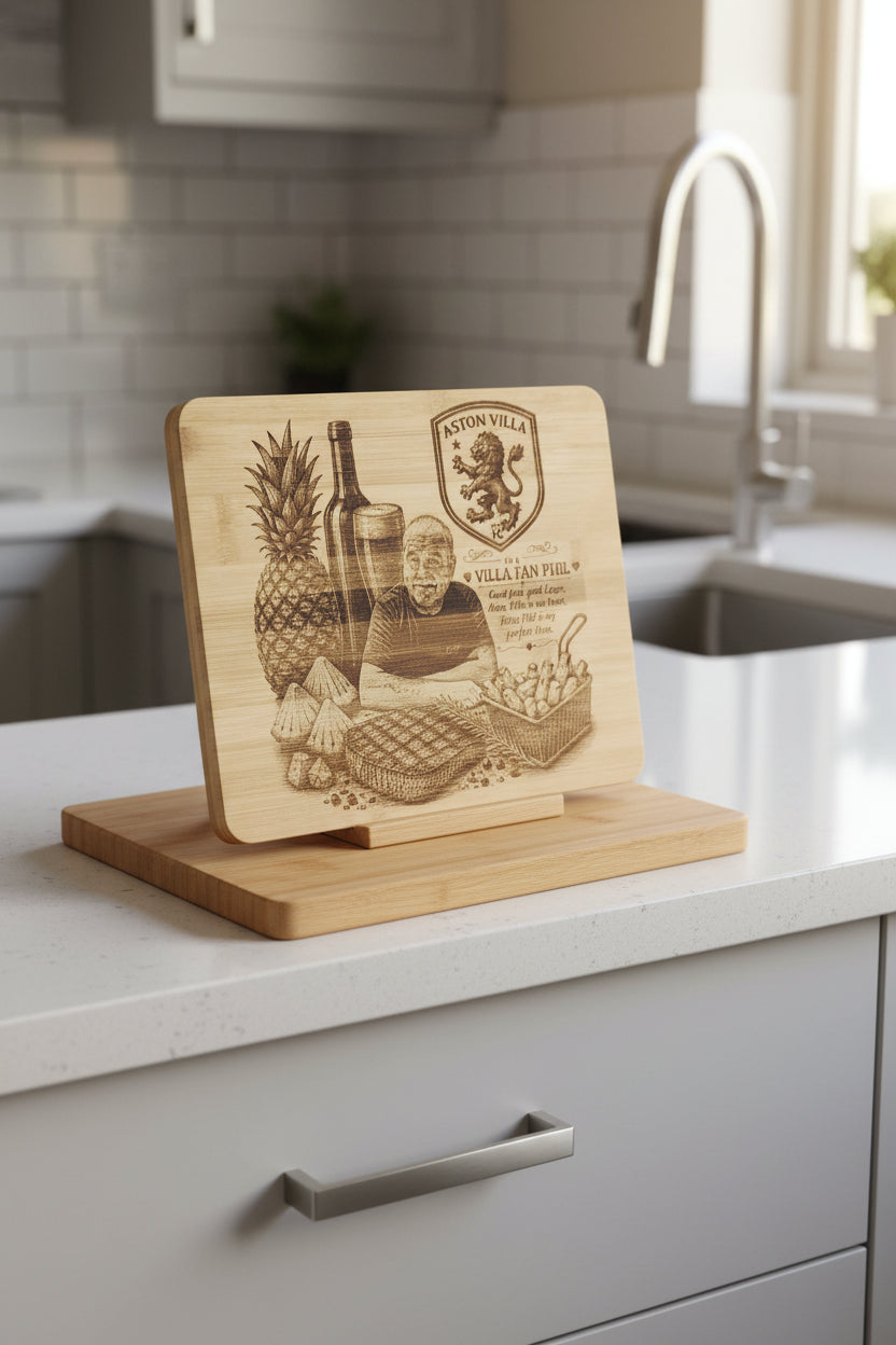 A rectangular wooden plaque featuring a laser-engraved design of a football player with a pineapple, wine bottle, and Aston Villa crest, displayed on a textured gray fabric surface.