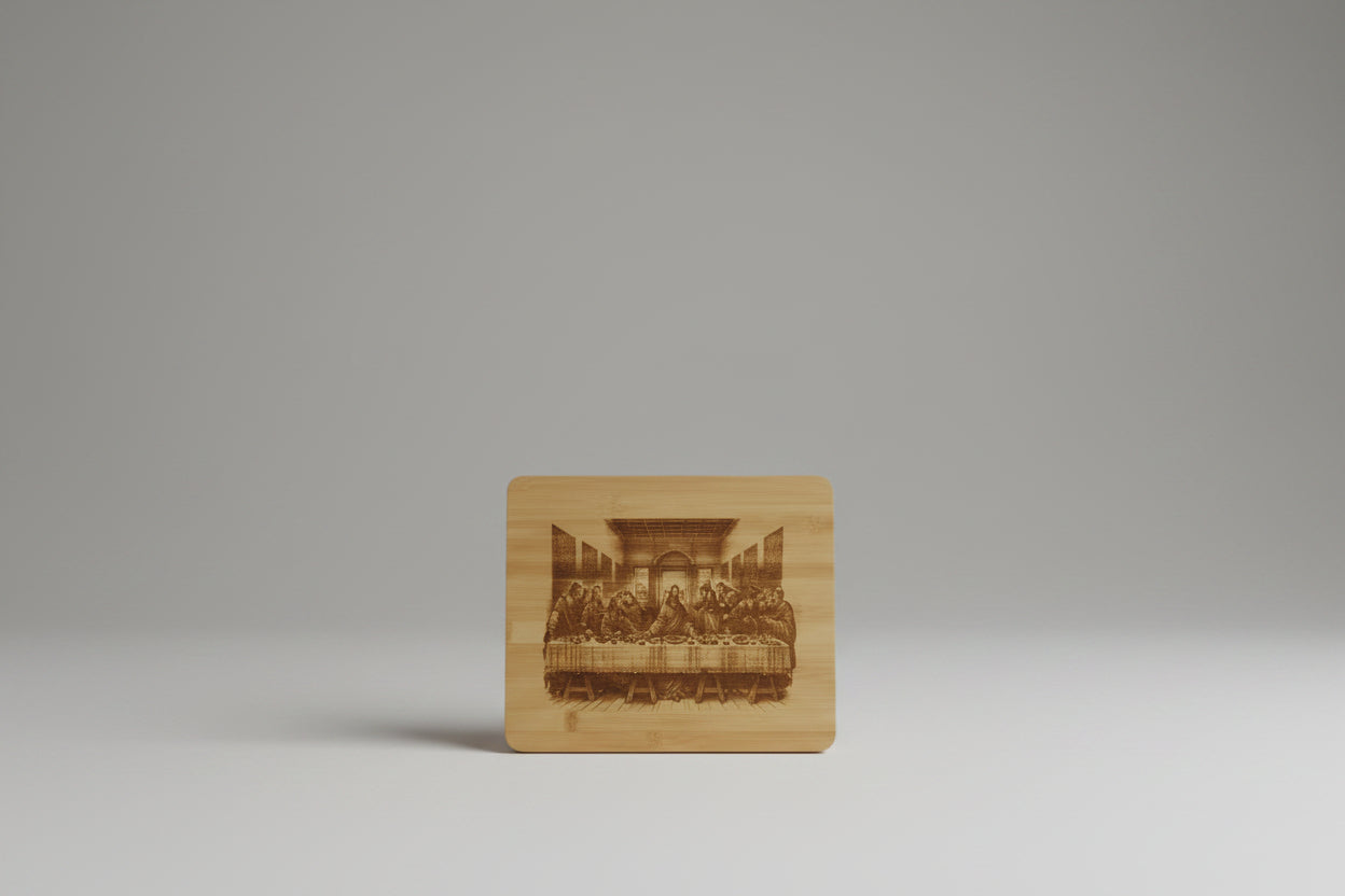 A rectangular bamboo cutting board with rounded corners, featuring a detailed laser-engraved depiction of Leonardo da Vinci's Last Supper on the front face.