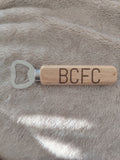Bamboo handle bottle opener.