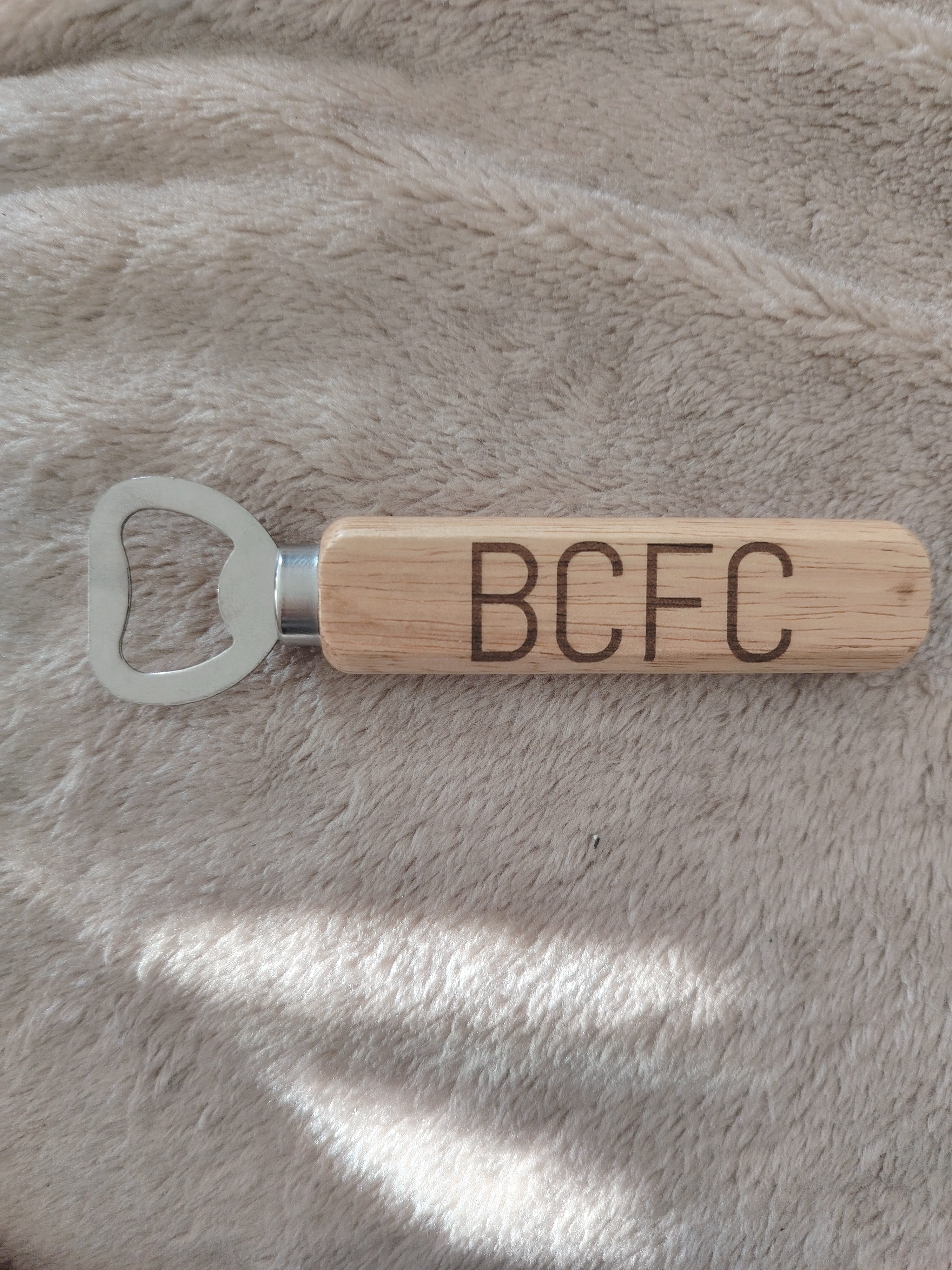 Bamboo handle bottle opener.